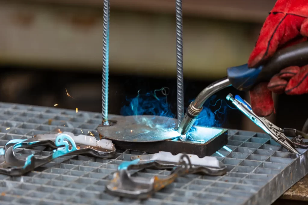 Details of welding activities - a welder is welding steel compon