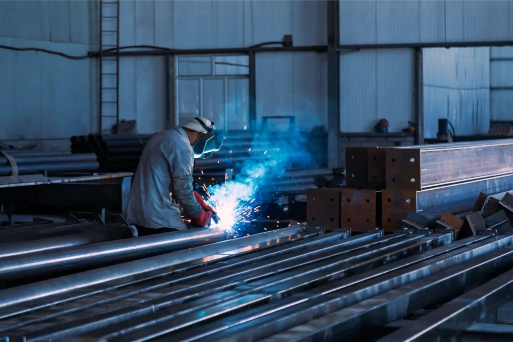 Industrial welder welding metal profiles